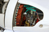Close-up of a white electric motor showing internal copper windings, green wires, and electronic components through an open side cover.